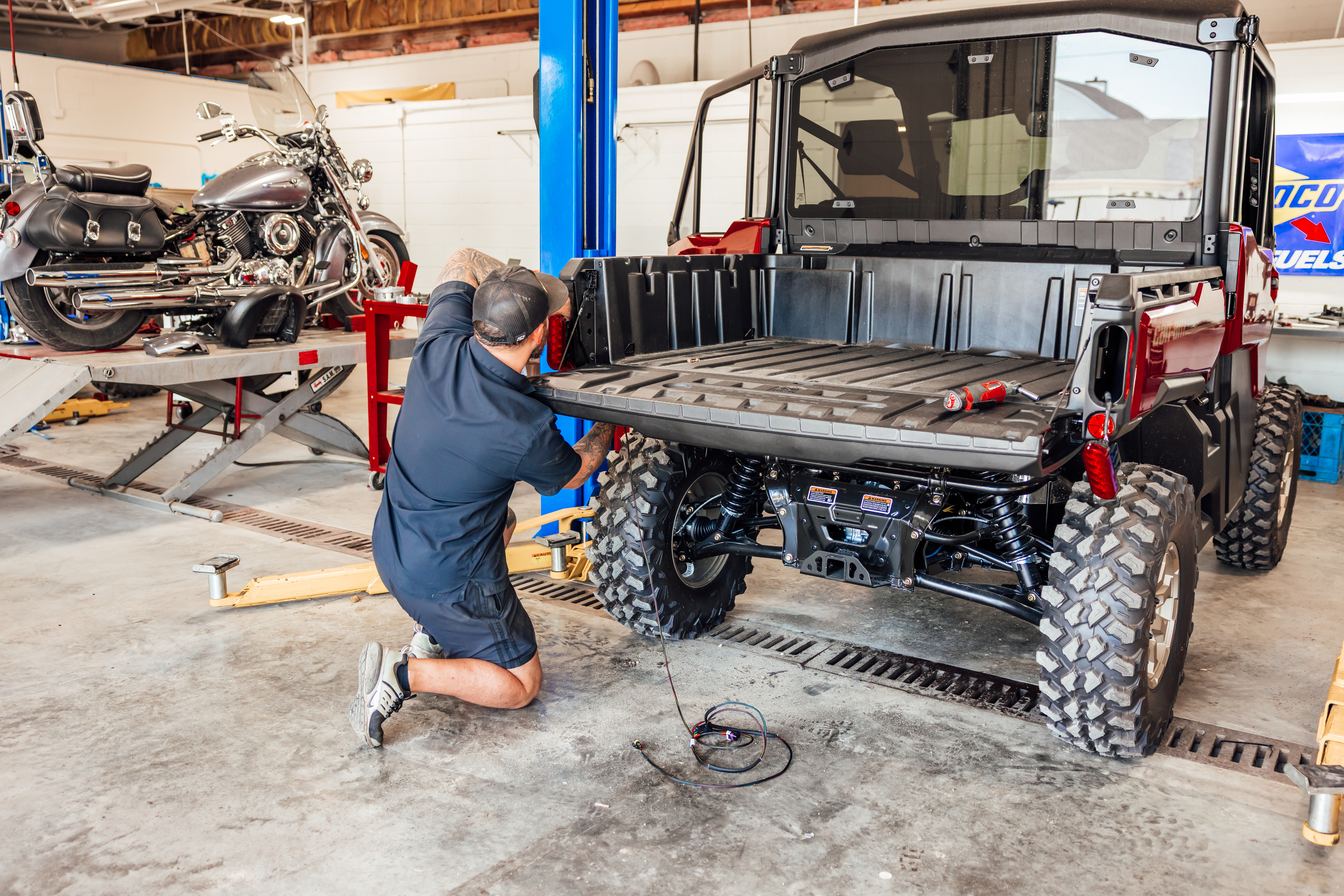 Pilson Powersports technician working on a UTV